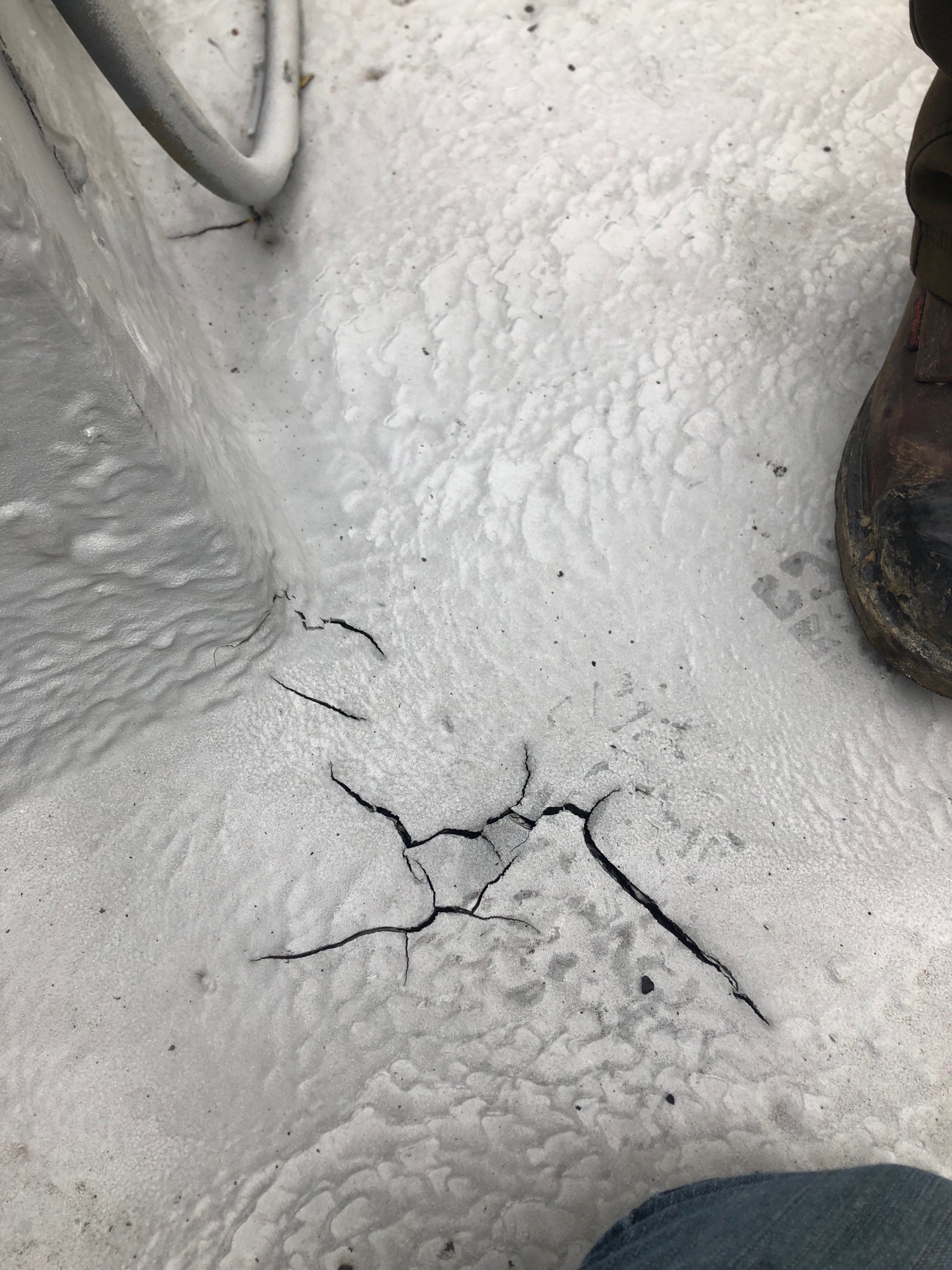 Polyurea membrane sprayed over an existing asphalt roof surface