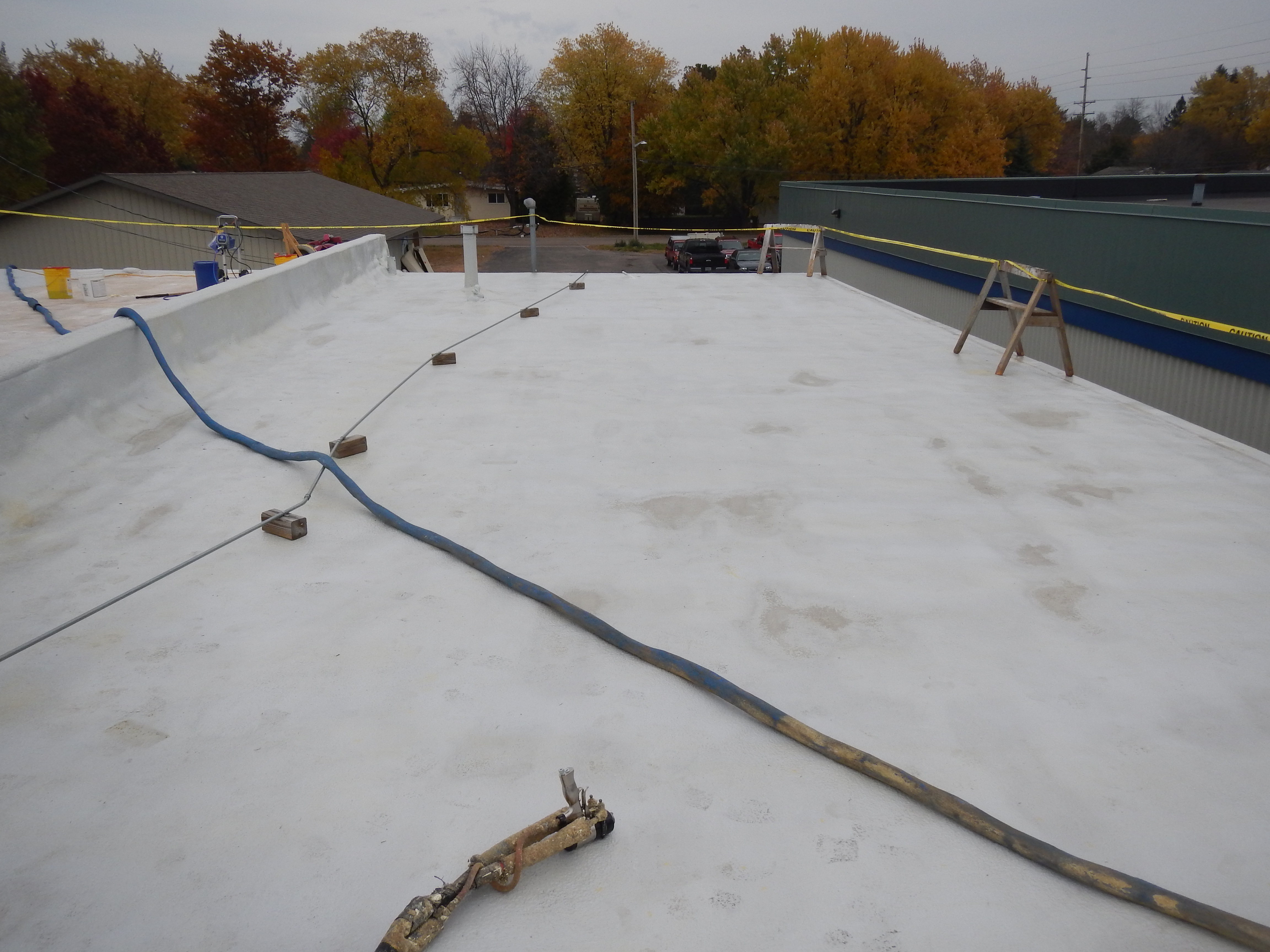 Multi-unit building roof restored with a seamless coating