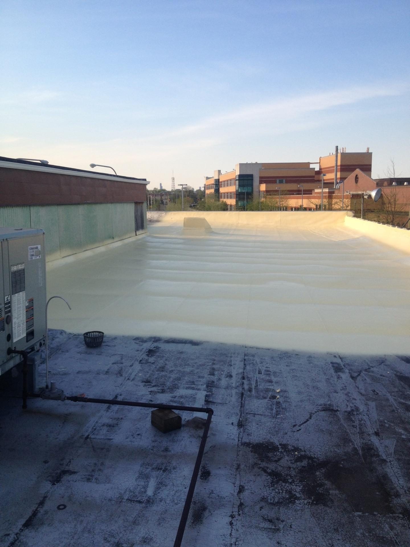 Roof valley and wall transition on an asphalt shingle roof